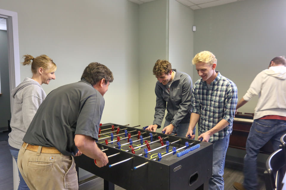 Employees playing Foosball